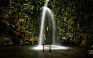 two kids under the waterfall