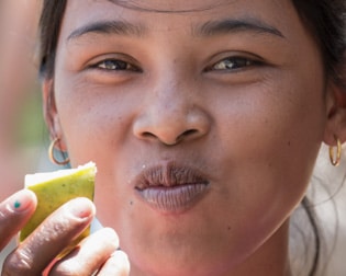 eating a green mango, Cambodia